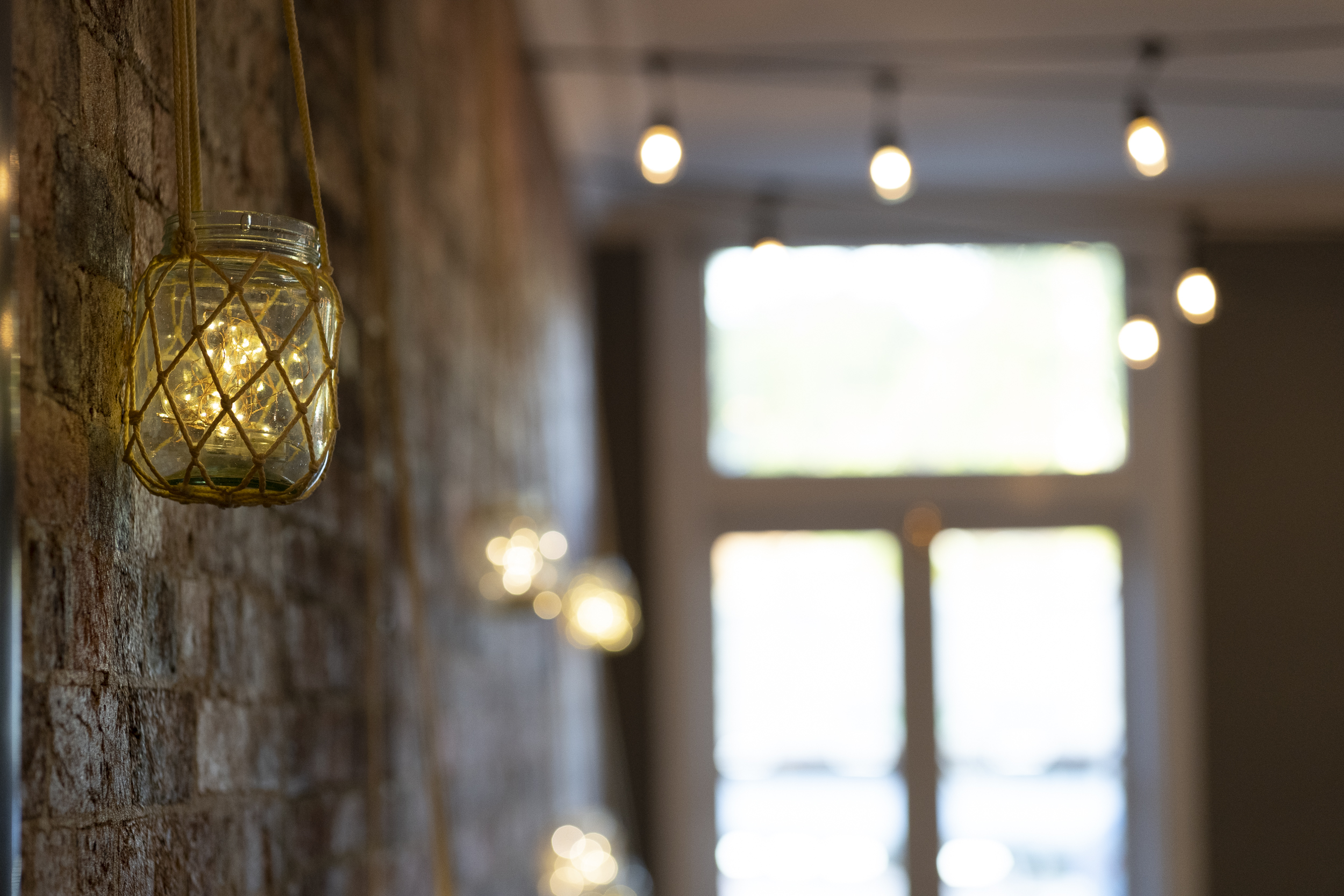Candlelit reception room with exposed brick walls at Transcontinental Hotel