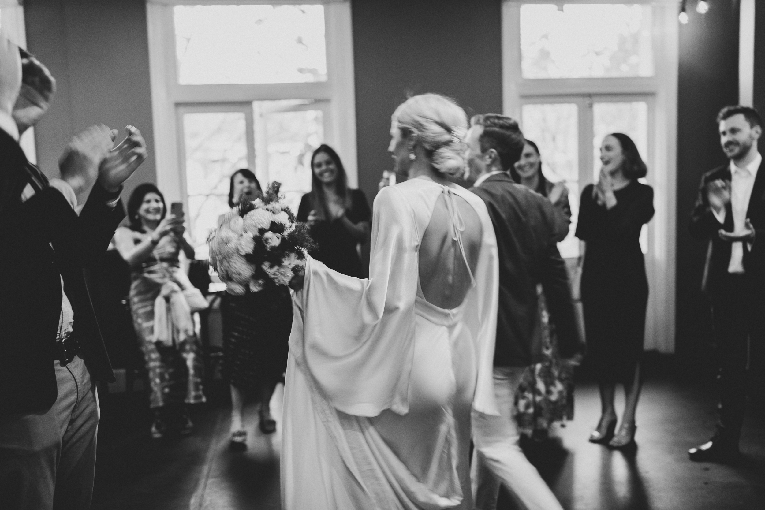 Wedding guests gathered for an evening celebration in a warm city reception space