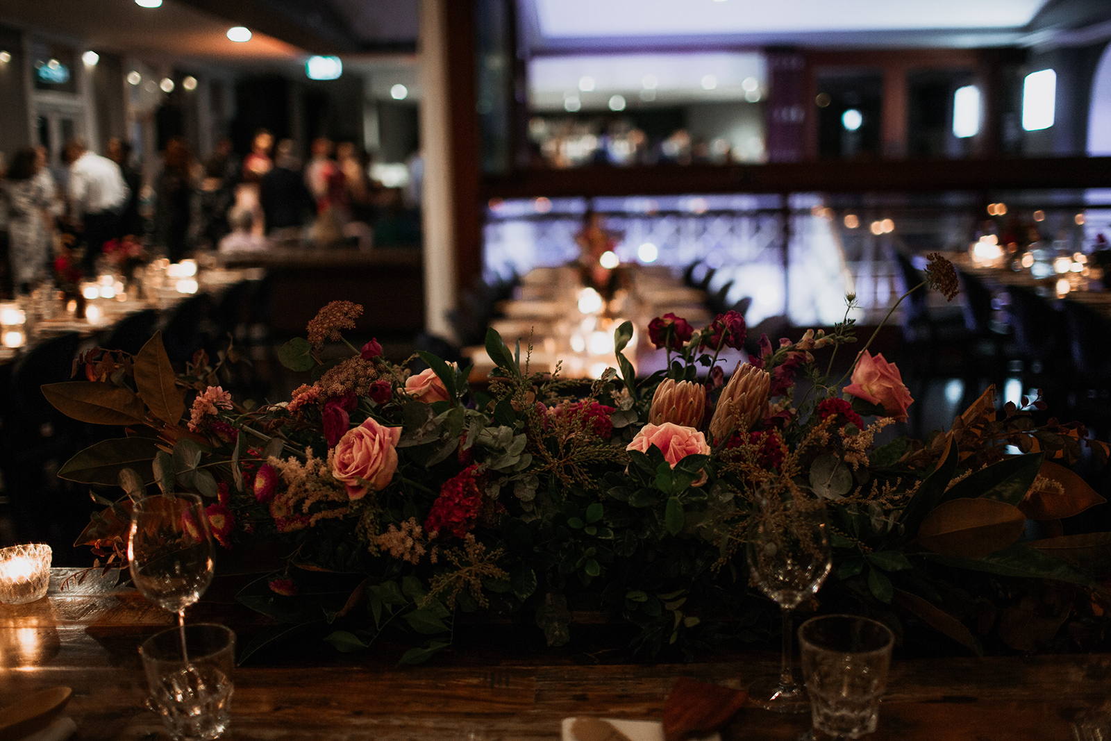 Styled wedding table with soft florals and glassware inside a city reception room