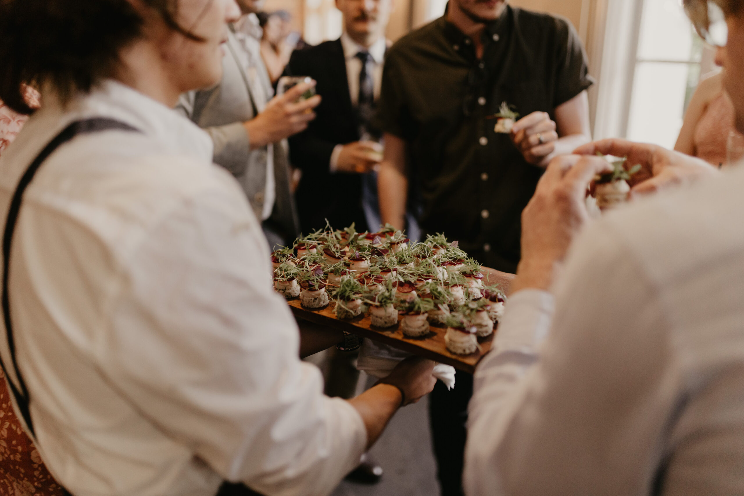 Roaming canapés served to guests during a relaxed city wedding celebration