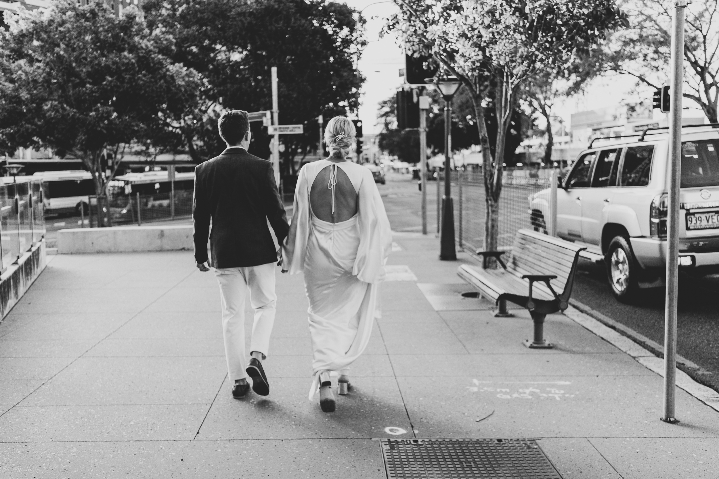 Couple planning guest travel routes near Roma Street Station before their wedding celebration