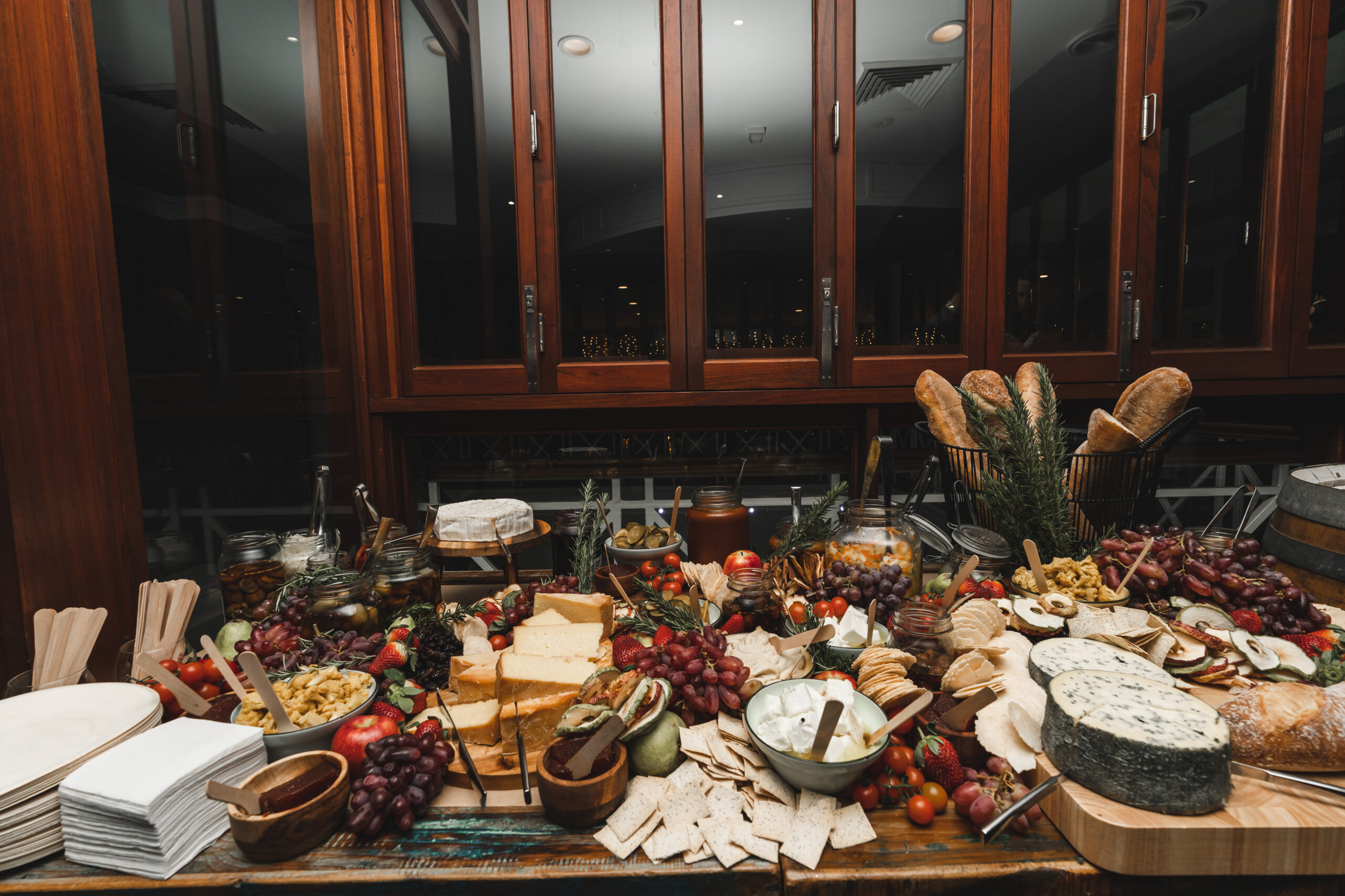 Shared feasting dishes placed along a styled wedding dining table
