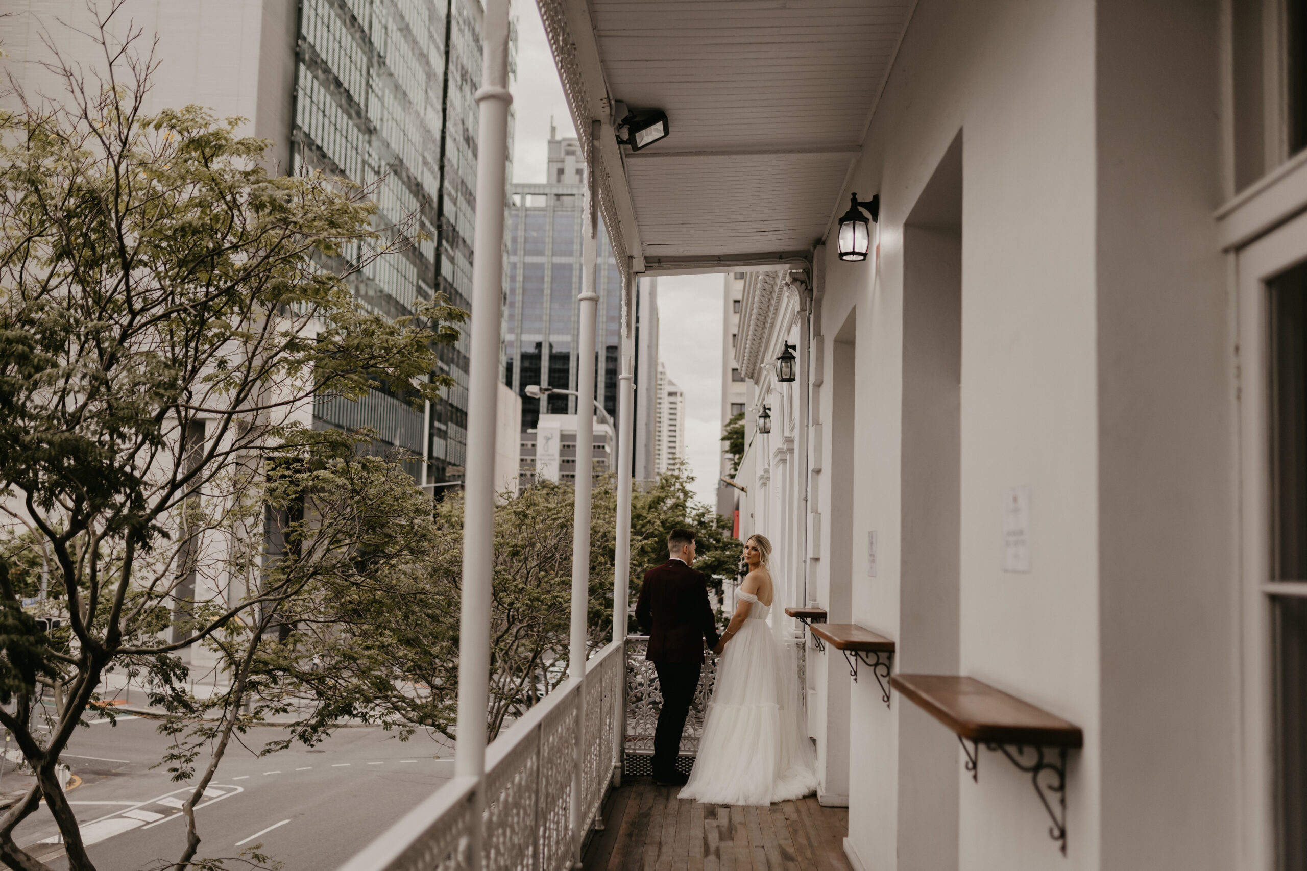 Wedding couple portrait on the original balcony at Transcontinental Hotel Weddings