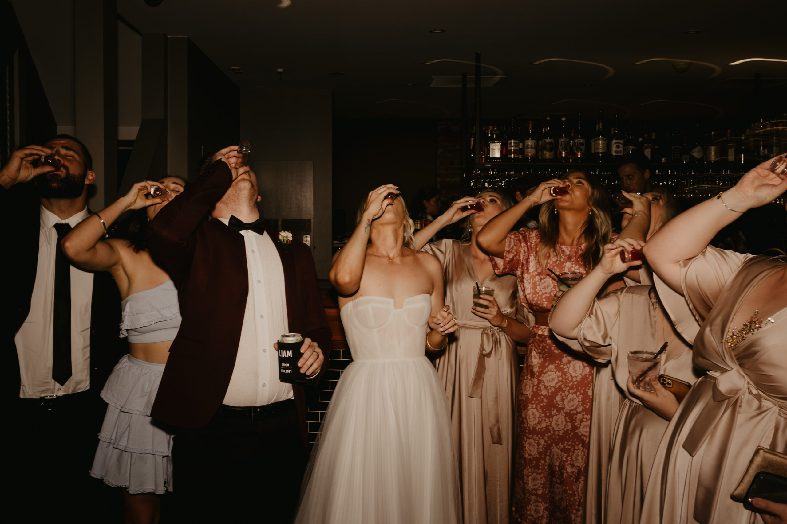 Guests gathered near the bar during an evening wedding celebration at Transcontinental Hotel