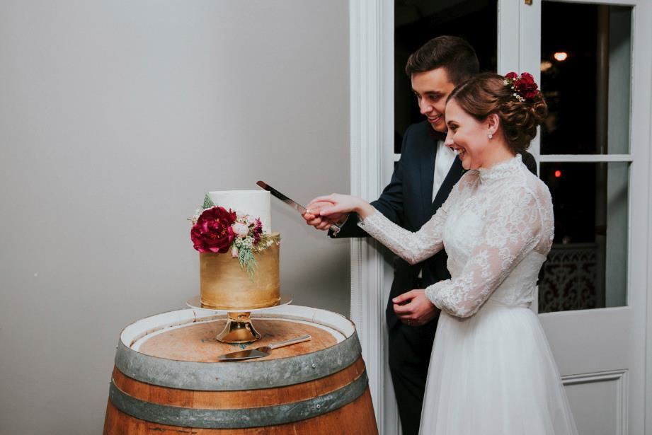 Couple cutting their wedding cake before the dance floor begins