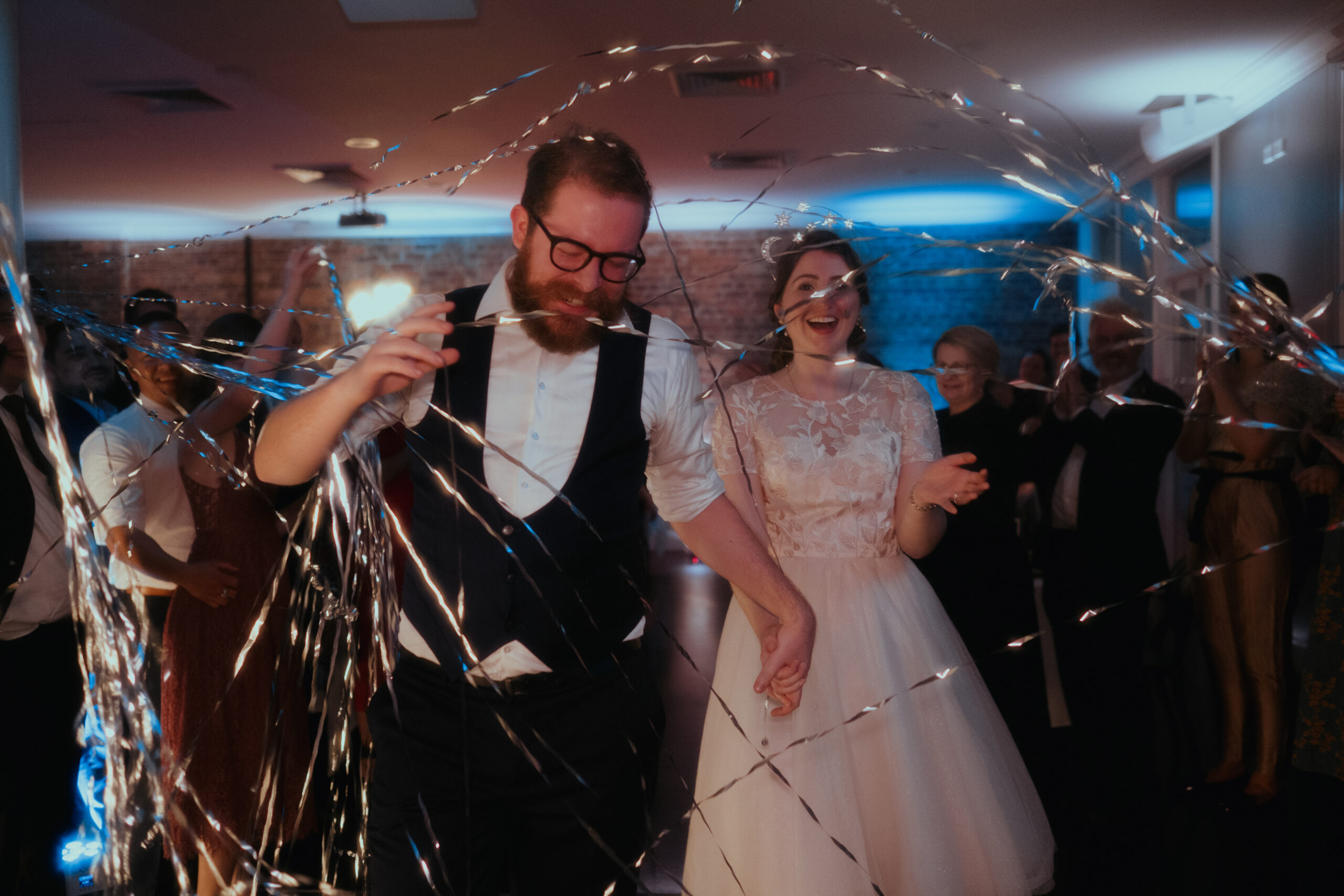 Guests farewelling the couple after an evening wedding celebration