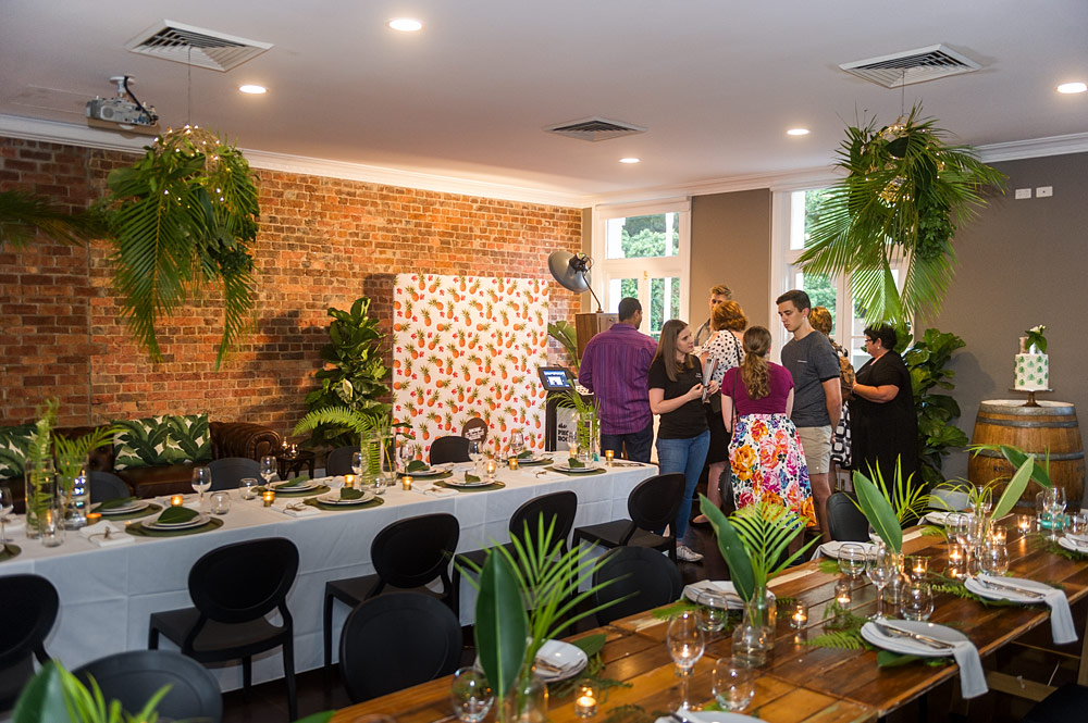 Styled event display with exposed brick and greenery inside Transcontinental Hotel