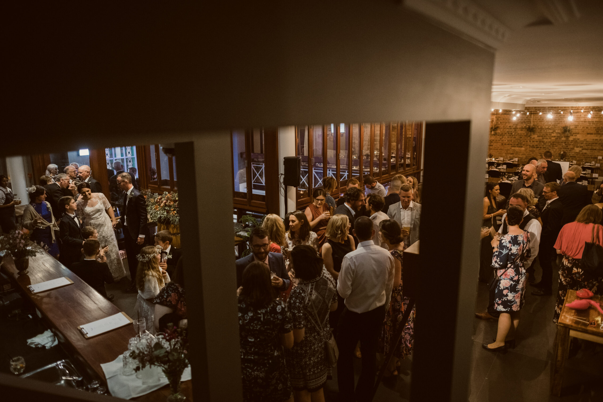 Guests arriving in formal attire for a George Street wedding celebration