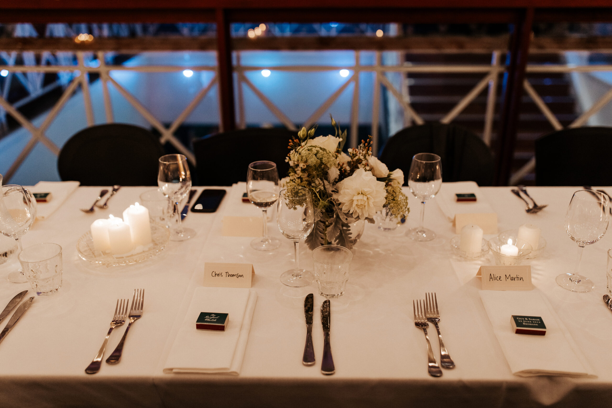 Wedding place settings with candles, glassware and florals inside Transcontinental Hotel