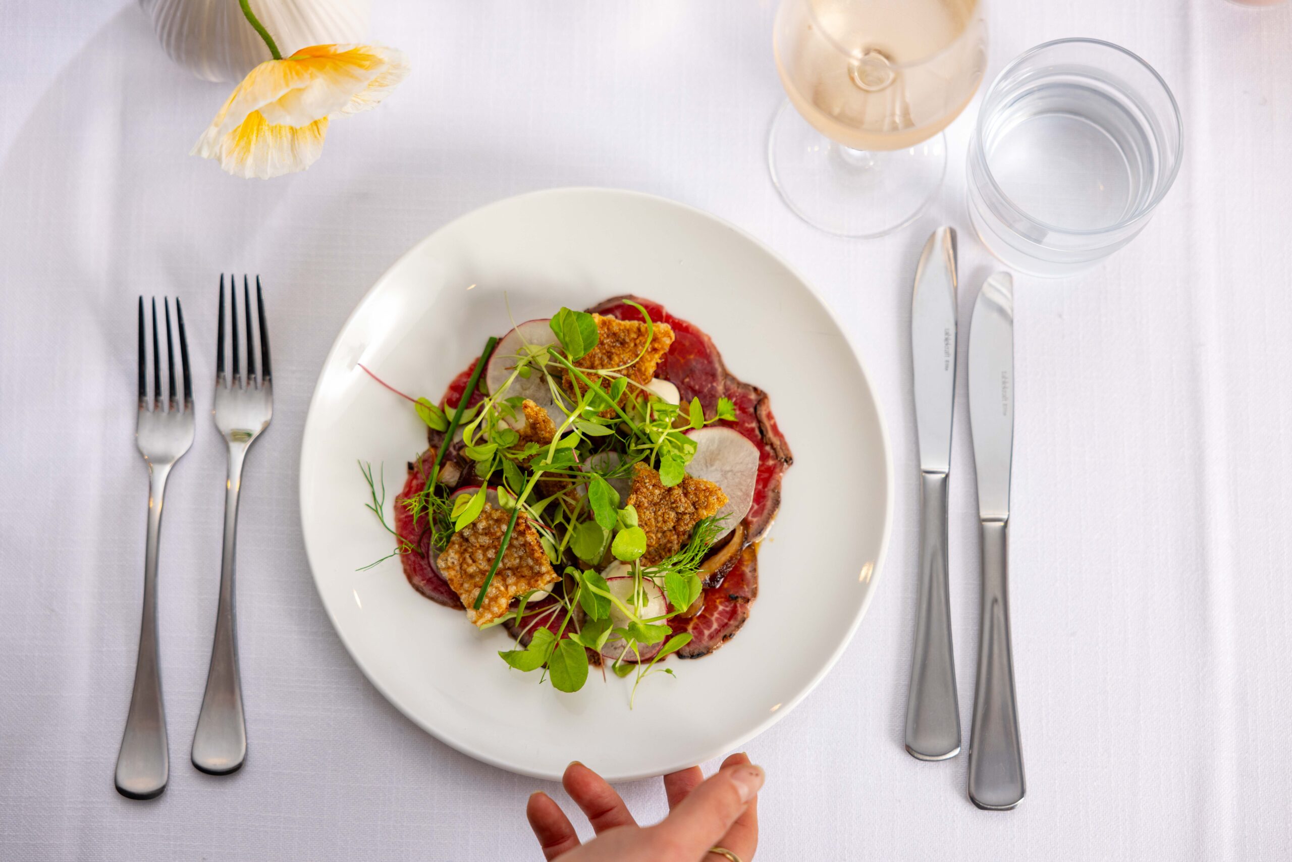 Plated wedding menu served with glassware and table setting at Transcontinental Hotel