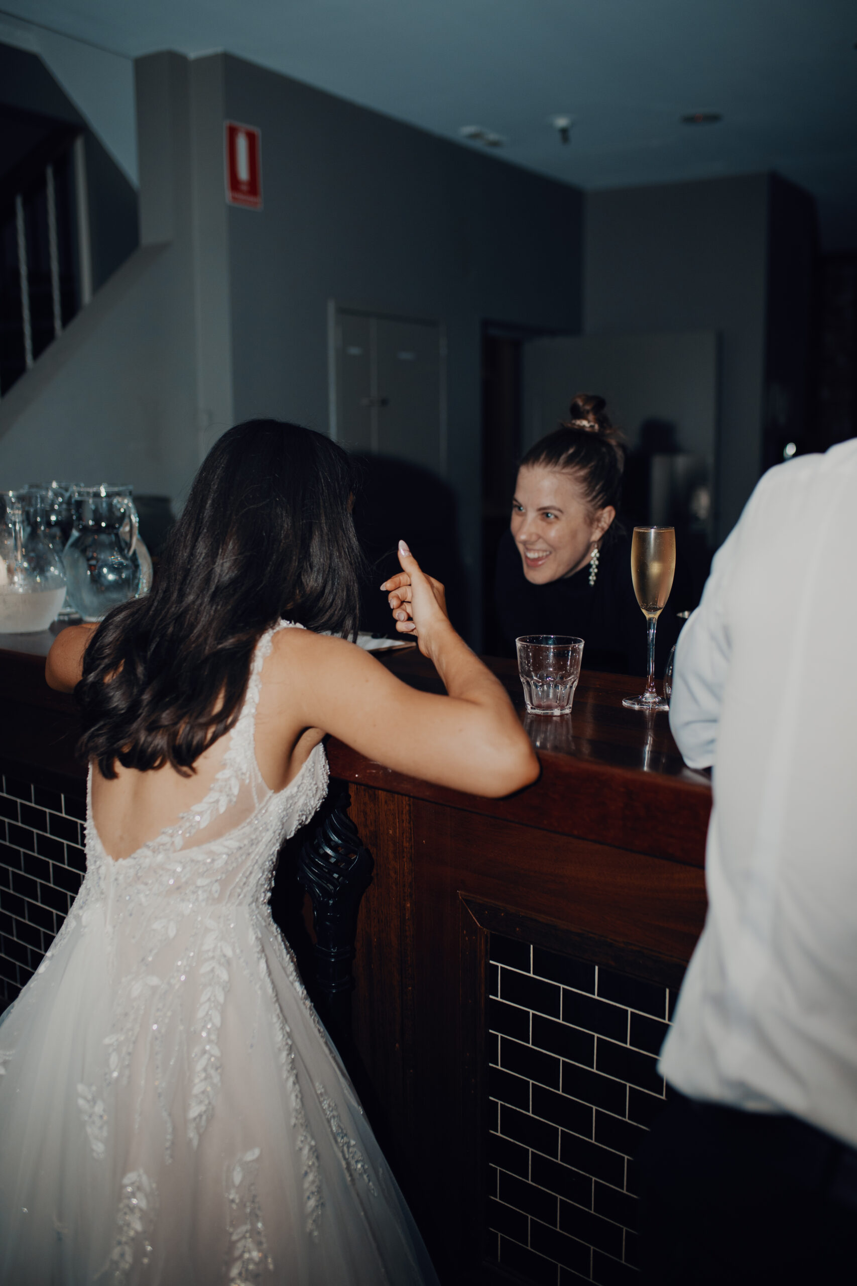 Wedding team member speaking with a couple during a Transcontinental Hotel reception