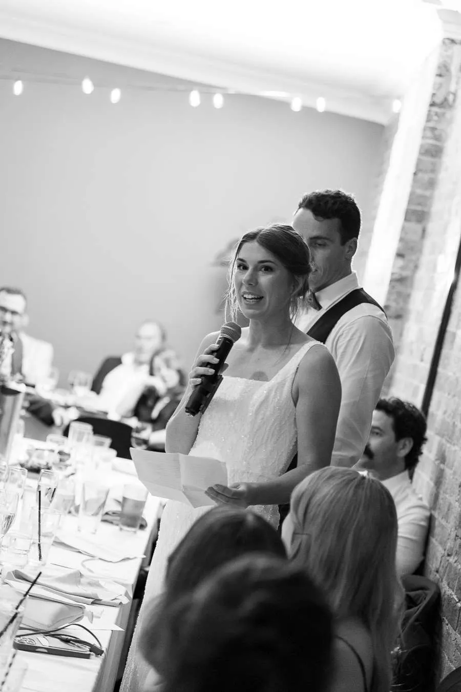 Couple giving speeches after securing their Brisbane wedding reception venue