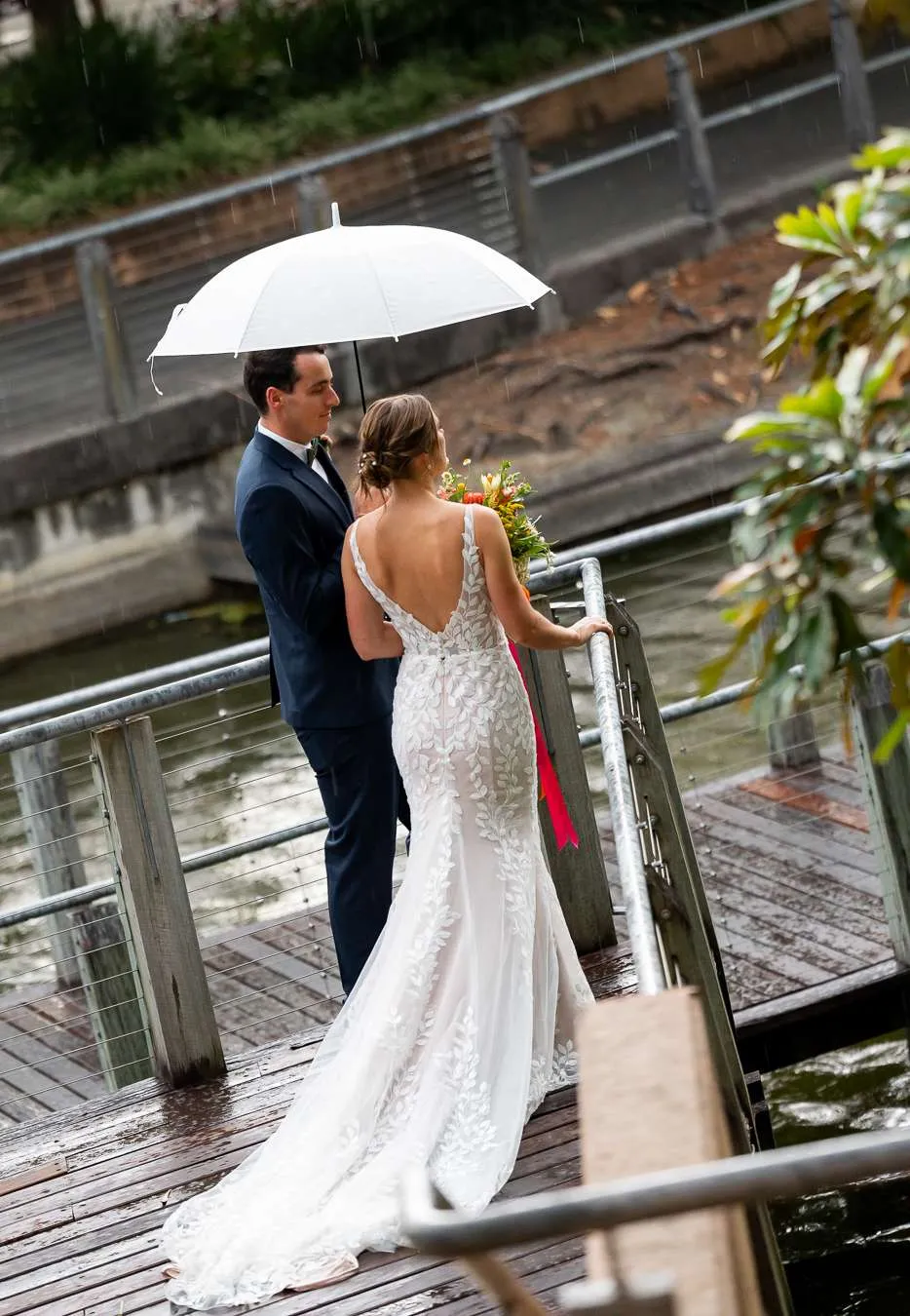 Couple portrait in rainy weather showing flexible wedding date planning in Brisbane