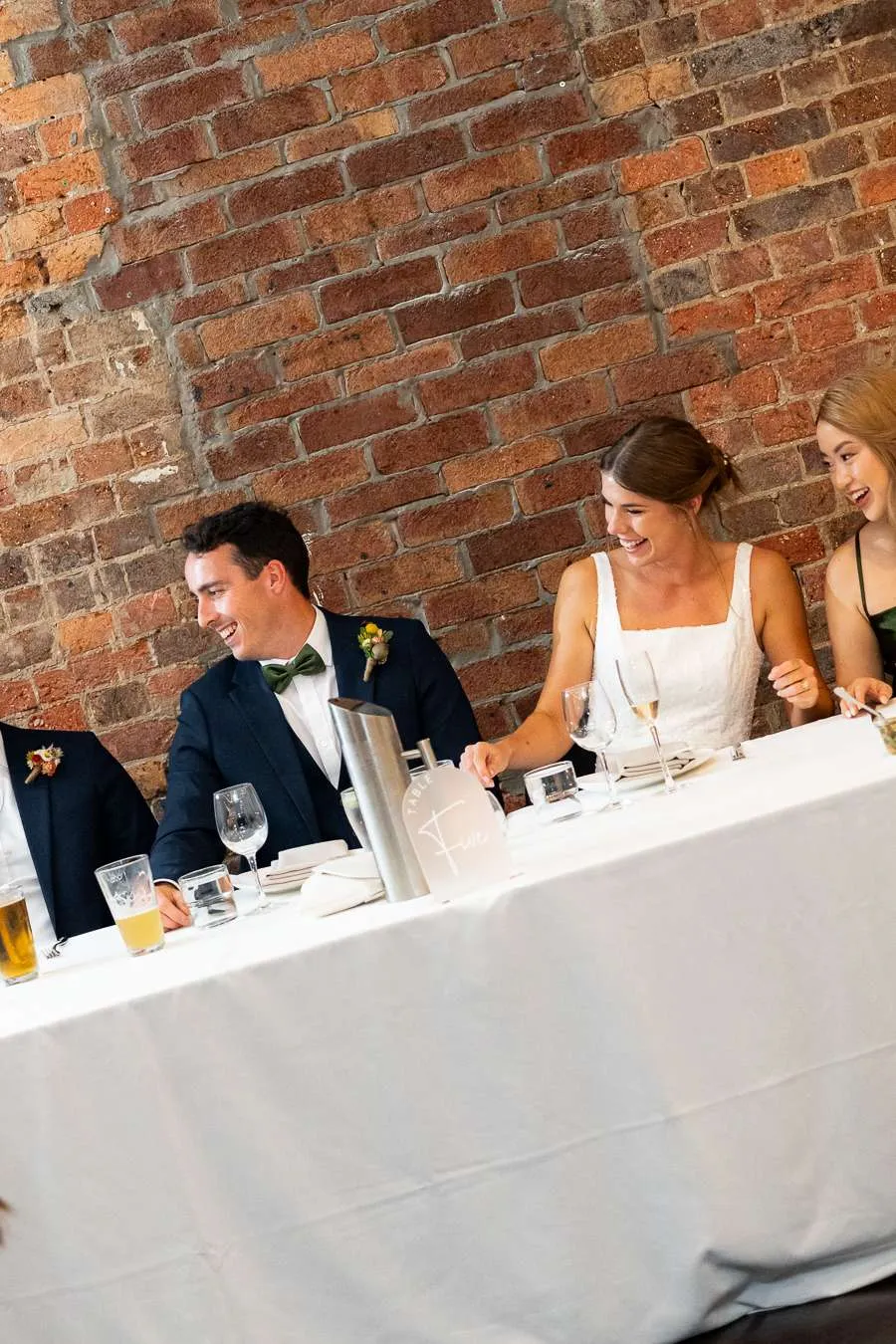 Couple and guests enjoying a seated Brisbane wedding reception indoors