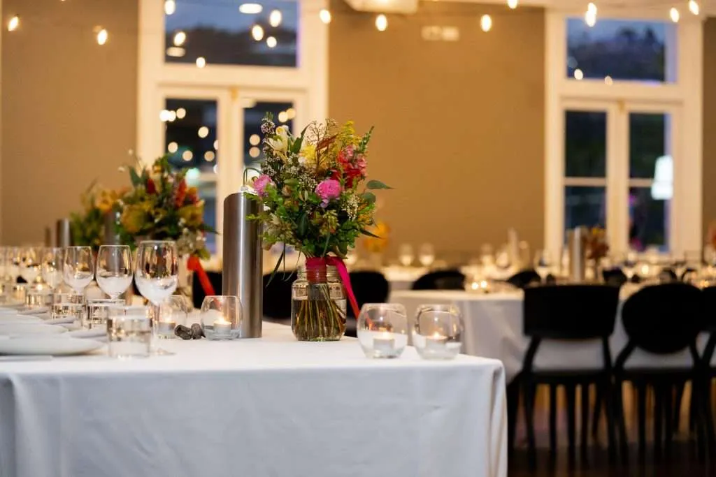 Seasonal wedding table styling with candles and florals inside a Brisbane reception space